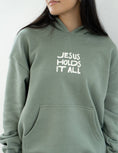Load image into Gallery viewer, Hoodie: Jesus Holds It All
